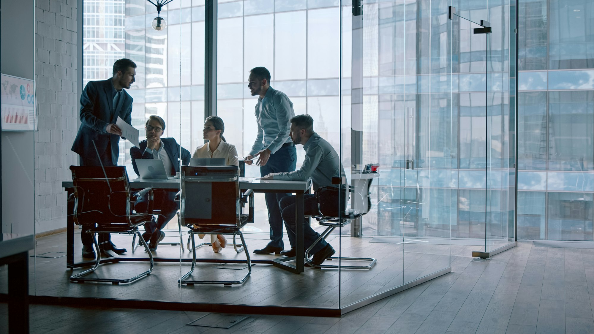 Corporate leader handing out statistics of the company's financial development strategy